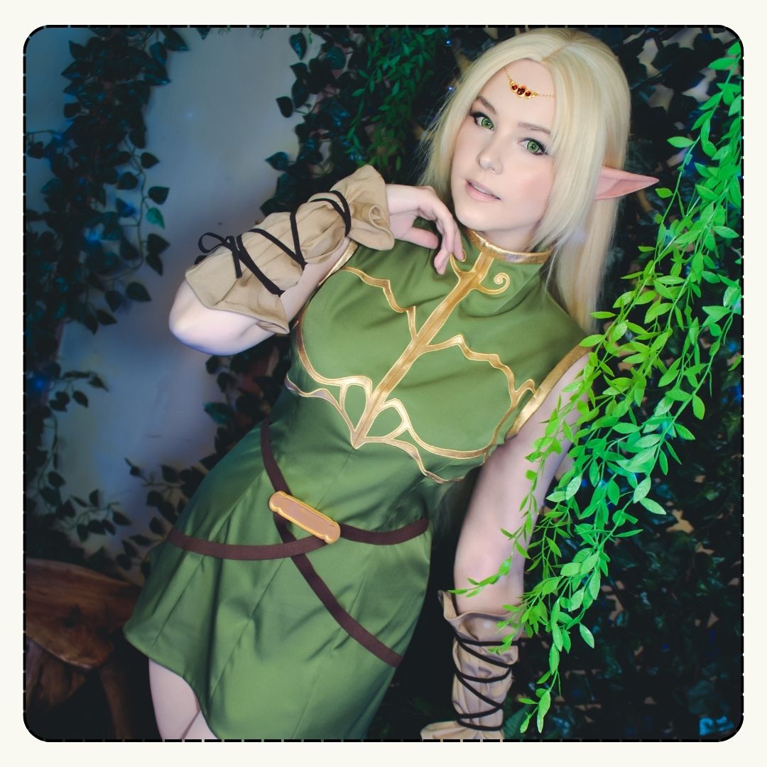 Person in a green elf costume standing among foliage
